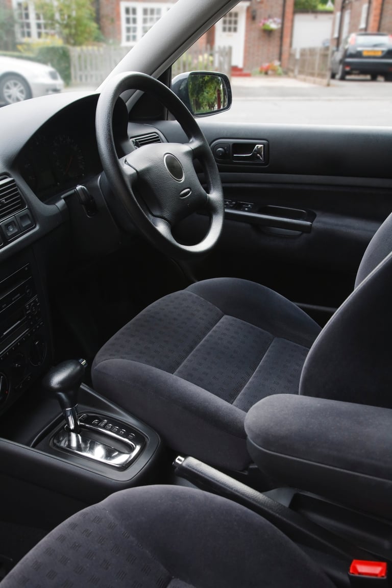 Interior of an european car with automatic transmission and gray velour cloth seats